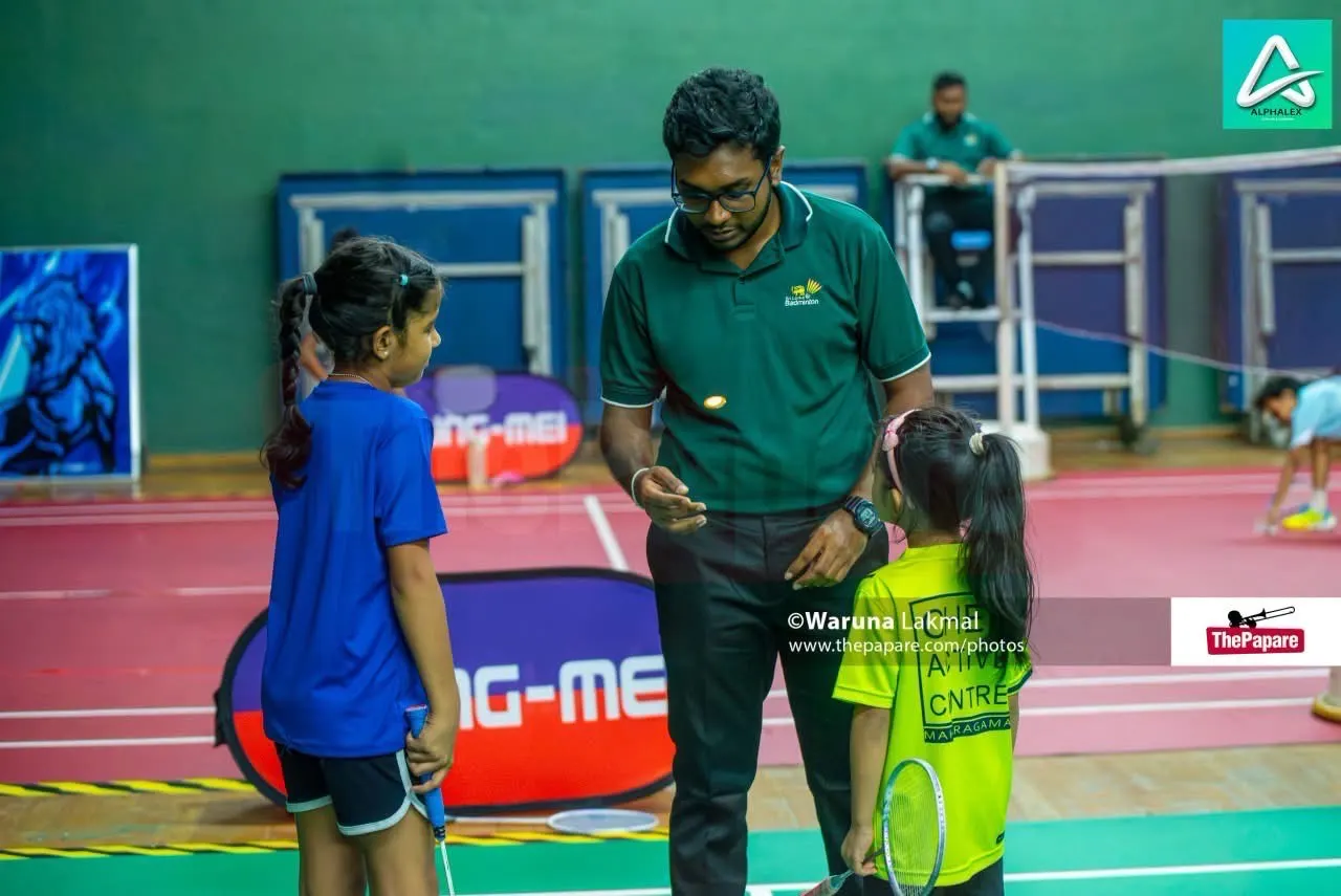 Coach speaking with young badminton players
